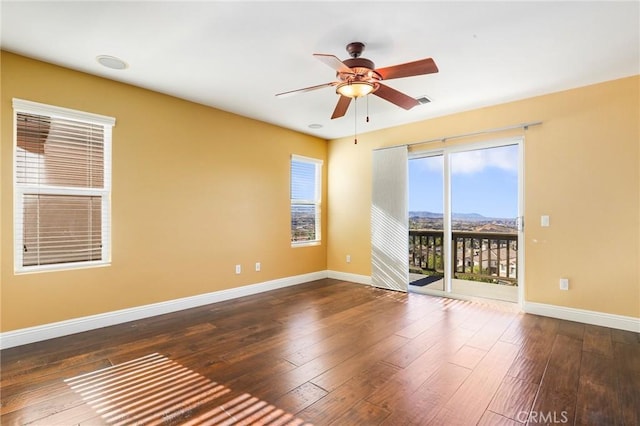 spare room featuring dark hardwood / wood-style floors and ceiling fan