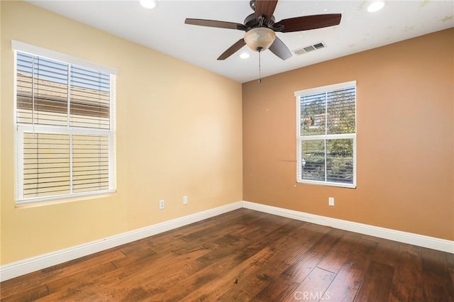 empty room featuring dark wood-type flooring and ceiling fan