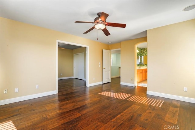 spare room with ceiling fan and dark hardwood / wood-style flooring