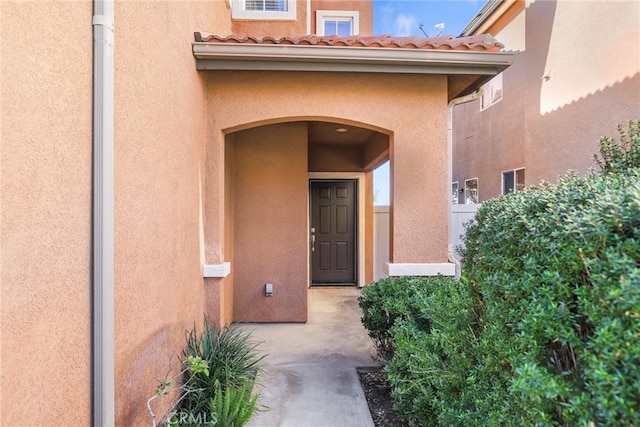 view of exterior entry featuring a patio