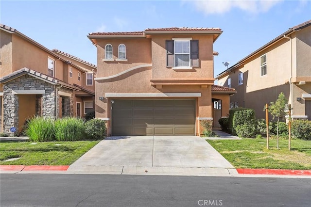 mediterranean / spanish-style house with a garage and a front lawn