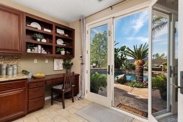 entryway featuring french doors and built in study area