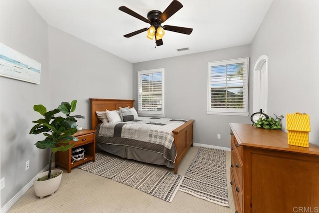 bedroom featuring a ceiling fan, visible vents, and baseboards