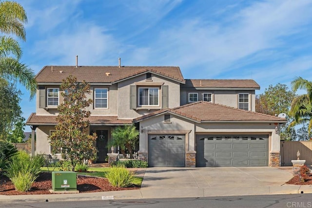 view of front of property featuring stone siding, concrete driveway, and stucco siding