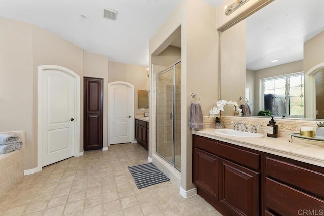 full bath with a stall shower, visible vents, and vanity