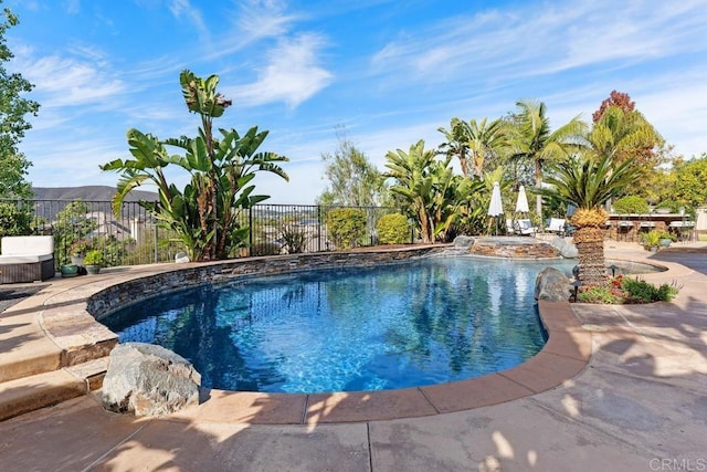 view of swimming pool featuring a fenced in pool and fence