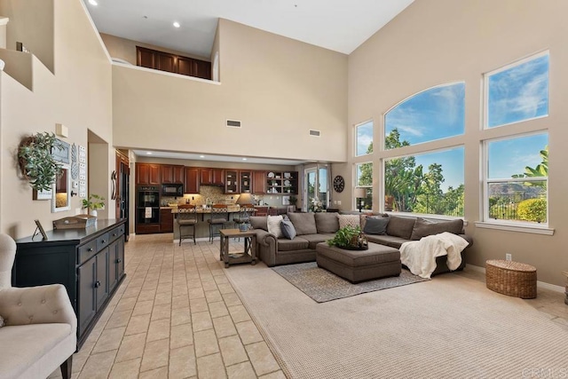 living area featuring recessed lighting, visible vents, and baseboards