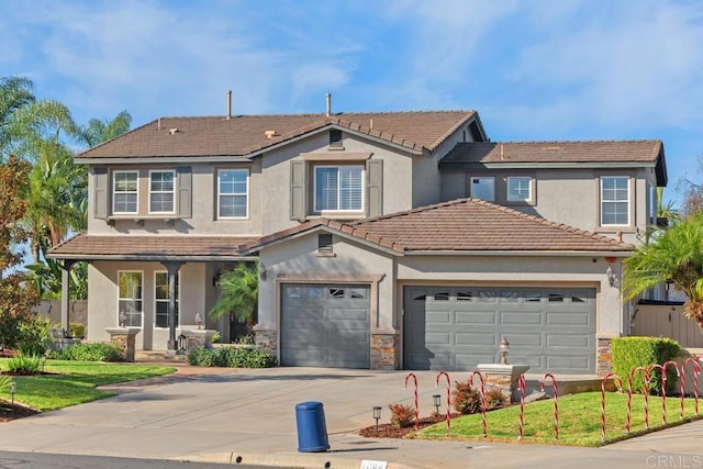 view of front of property with a porch, a tile roof, concrete driveway, stone siding, and a front yard