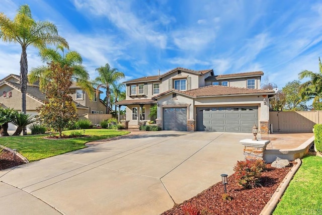 view of front facade featuring a garage, driveway, stucco siding, fence, and a front yard