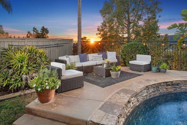 view of patio / terrace featuring an outdoor pool, a fenced backyard, and an outdoor hangout area