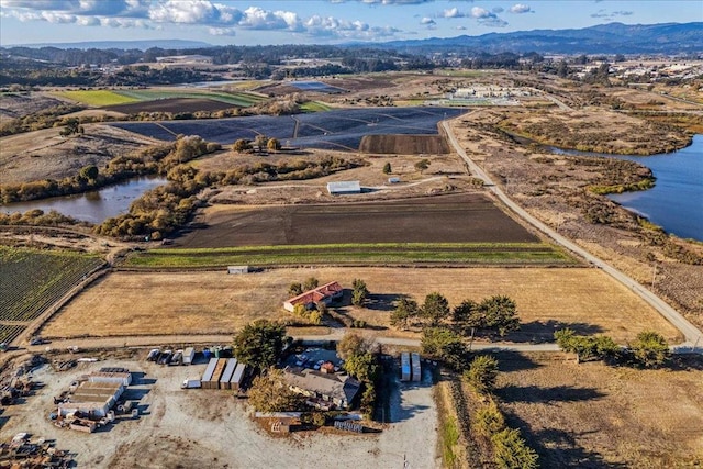 aerial view featuring a water and mountain view and a rural view