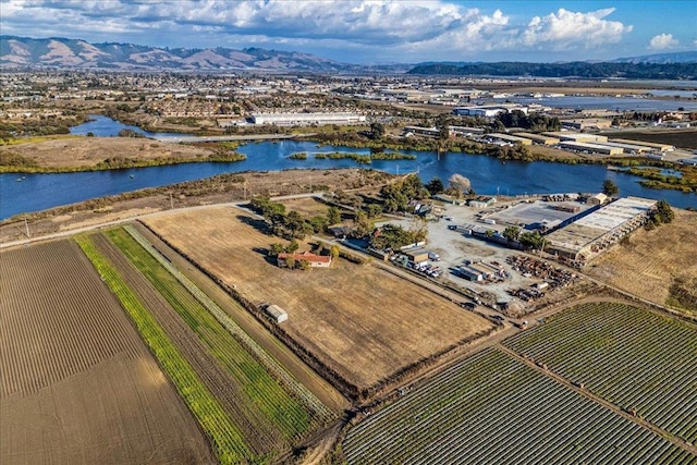 drone / aerial view featuring a water and mountain view