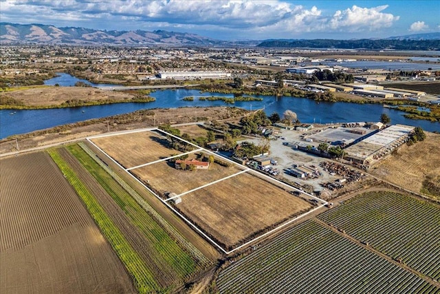 birds eye view of property with a water and mountain view