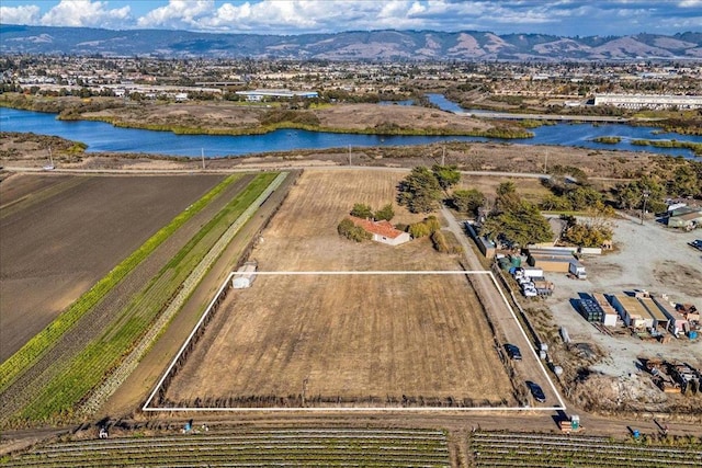 drone / aerial view with a rural view and a water and mountain view