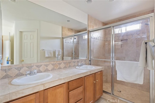 9551 San Rafael Dr, Desert Hot Springs, CA 92240 - bathroom featuring vanity, a shower with shower door, and backsplash