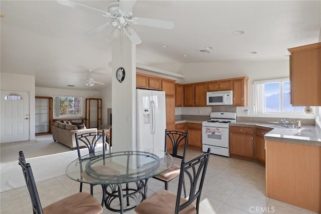 9551 San Rafael Dr, Desert Hot Springs, CA 92240 - dining area featuring vaulted ceiling, ceiling fan, healthy amount of natural light, and light tile patterned floors