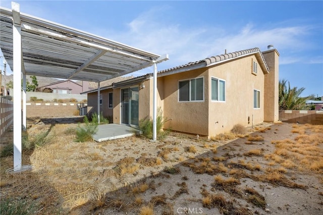 9551 San Rafael Dr, Desert Hot Springs, CA 92240 - rear view of house with stucco siding and a patio area