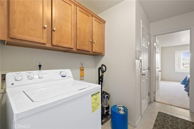 9551 San Rafael Dr, Desert Hot Springs, CA 92240 - laundry area featuring washer / clothes dryer, cabinet space, and light tile patterned flooring