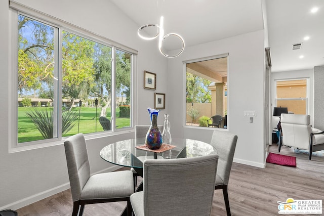 dining space featuring plenty of natural light and light hardwood / wood-style floors