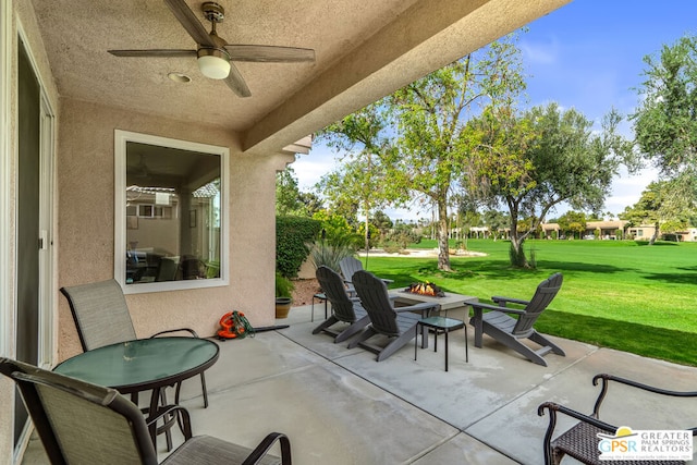 view of patio with a fire pit and ceiling fan