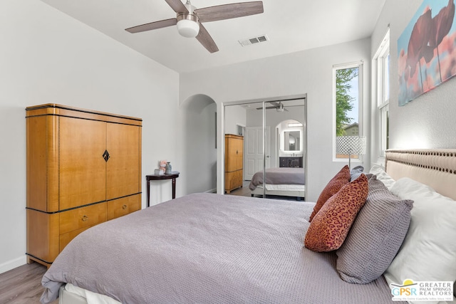 bedroom with ceiling fan, a closet, and light hardwood / wood-style floors