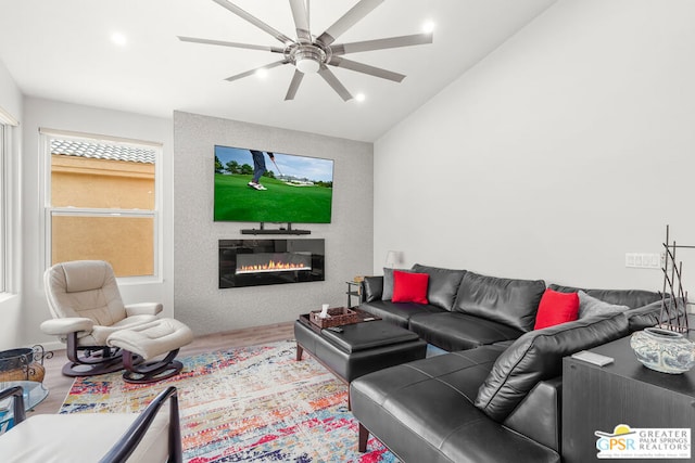 living room featuring hardwood / wood-style floors, ceiling fan, and lofted ceiling