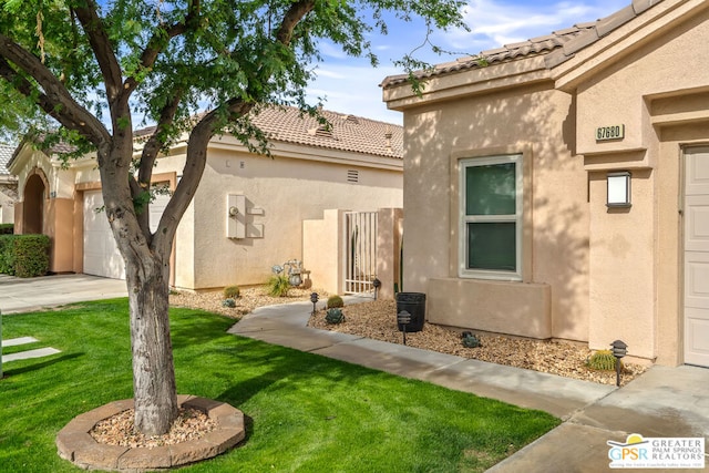 exterior space with a garage and a yard