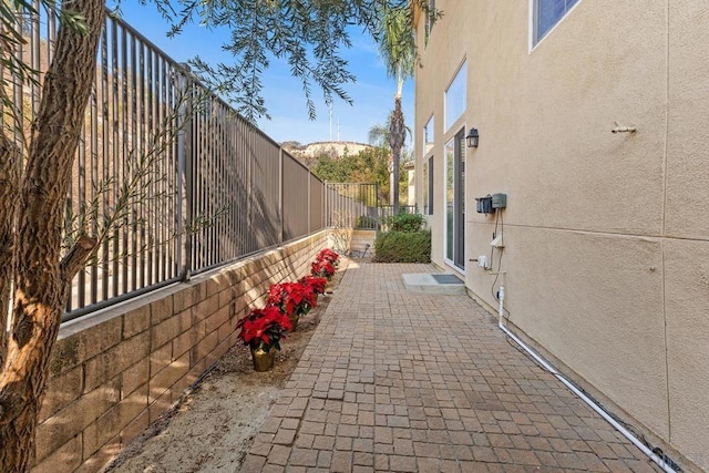 view of side of property featuring a mountain view and a patio