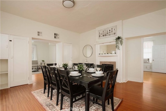 dining space with wood-type flooring