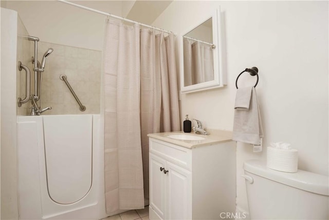 bathroom featuring tile patterned floors, vanity, and toilet