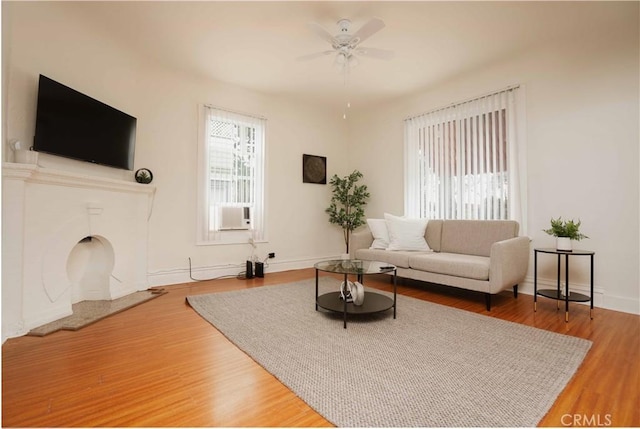 living room featuring hardwood / wood-style flooring and ceiling fan