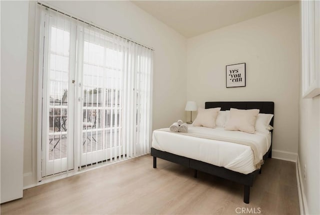 bedroom featuring access to outside and light hardwood / wood-style floors