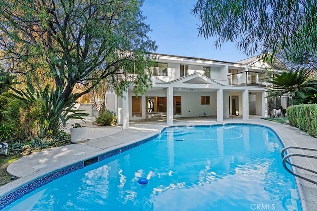 back of property with a patio area and a balcony