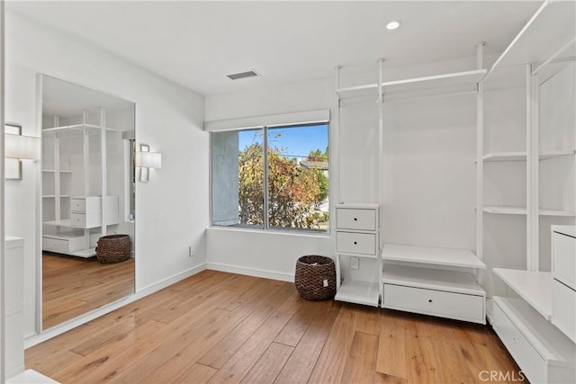 spacious closet with light hardwood / wood-style floors