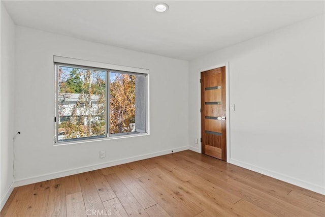 unfurnished room with light wood-type flooring