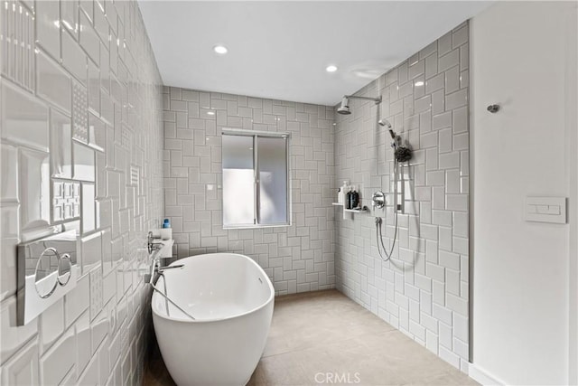 bathroom with tile patterned floors, tile walls, and independent shower and bath