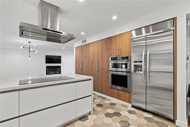 kitchen featuring white cabinets, range hood, and appliances with stainless steel finishes