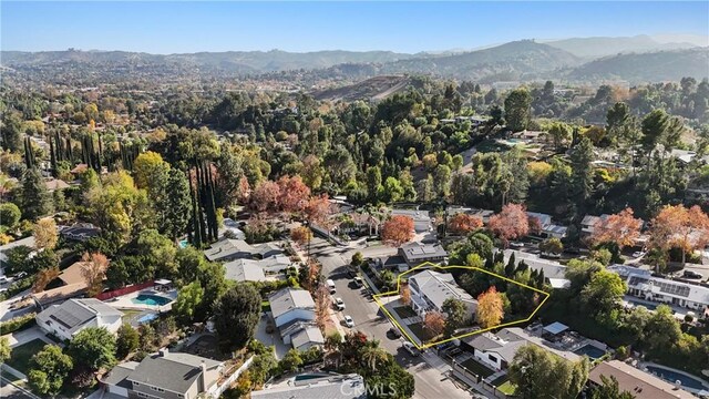 birds eye view of property with a mountain view