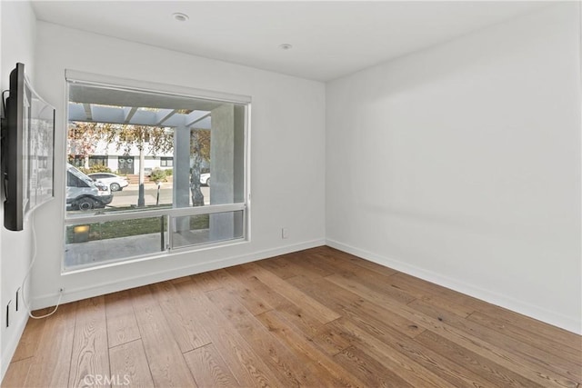 unfurnished room with light hardwood / wood-style flooring