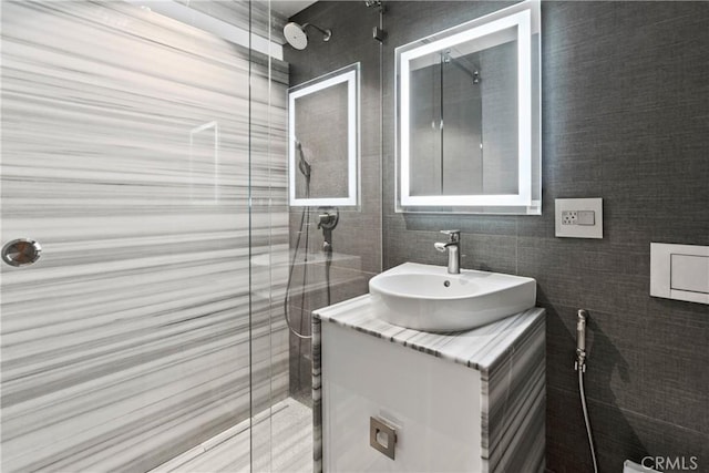 bathroom featuring vanity and tile walls