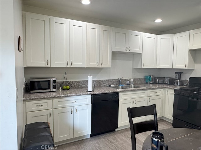 kitchen featuring black appliances, light hardwood / wood-style floors, white cabinets, and sink