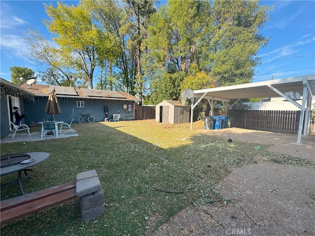 view of yard featuring a storage unit and a patio area