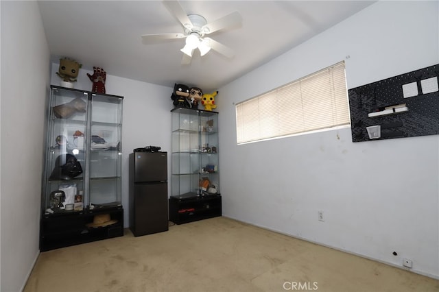 interior space featuring ceiling fan and light carpet