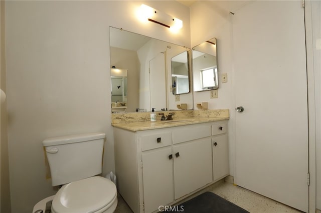 bathroom featuring toilet and vanity