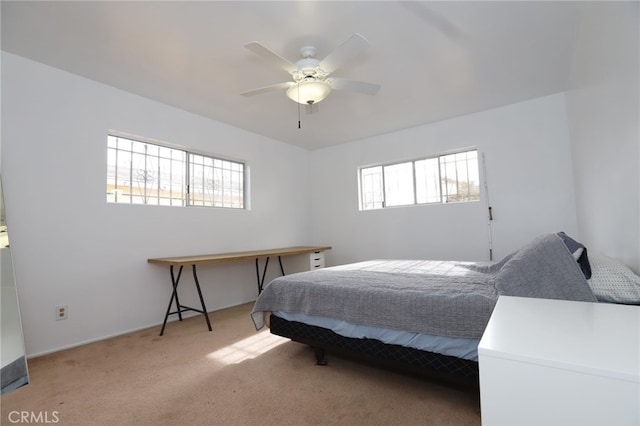 bedroom featuring light carpet and ceiling fan