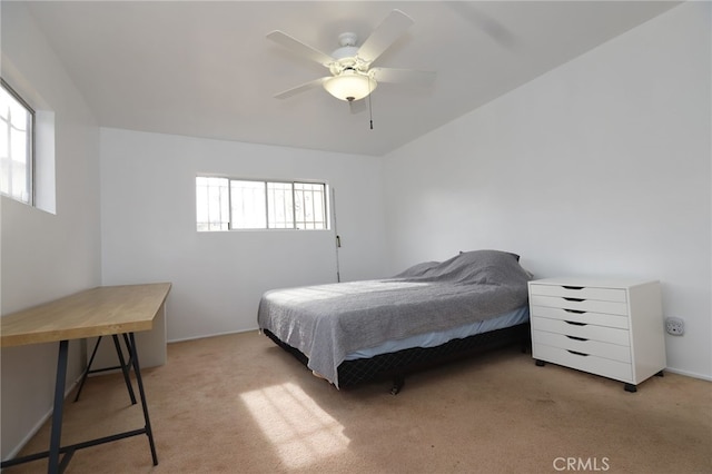 carpeted bedroom with ceiling fan and multiple windows