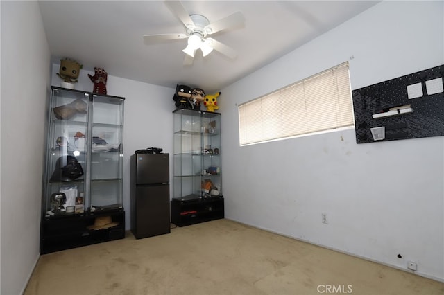 interior space with ceiling fan and light colored carpet