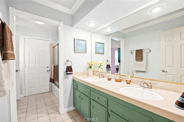 full bathroom with crown molding, double vanity, tile patterned floors, and a sink