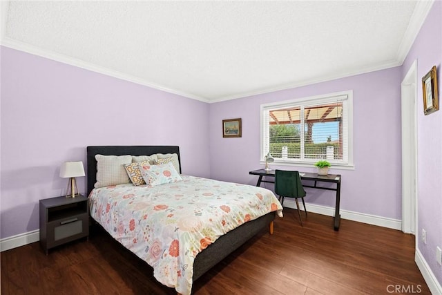 bedroom featuring ornamental molding, baseboards, and wood finished floors