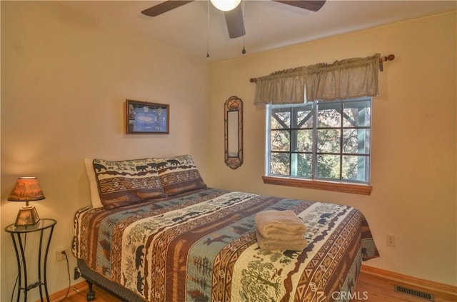 bedroom with hardwood / wood-style floors and ceiling fan